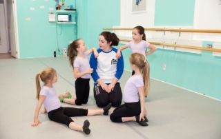 Mini Dancers take a break with Miss Lainy to relax after a hot hip-hop class.