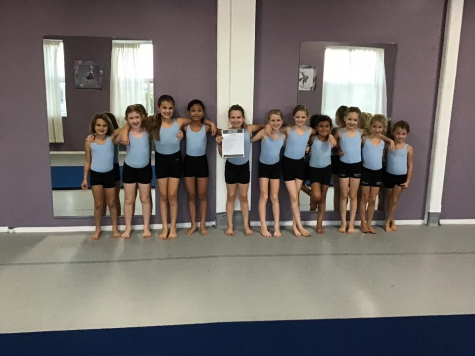 Junior Acro posed for a photo after completing their "Above and Beyond" lists!